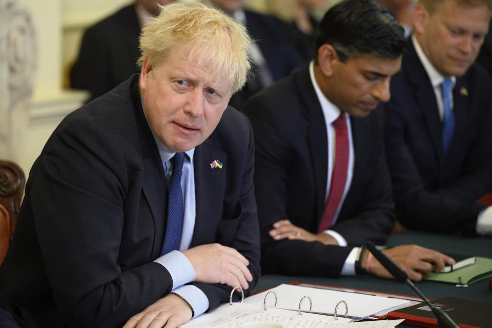 Britain's Prime Minister Boris Johnson, left, addresses his Cabinet during his weekly Cabinet meeting in Downing Street on Tuesday, June 7, 2022 in London. Johnson was meeting his Cabinet and trying to patch up his tattered authority on Tuesday after surviving a no-confidence vote that has left him a severely weakened leader. (Leon Neal/Pool Photo via AP)