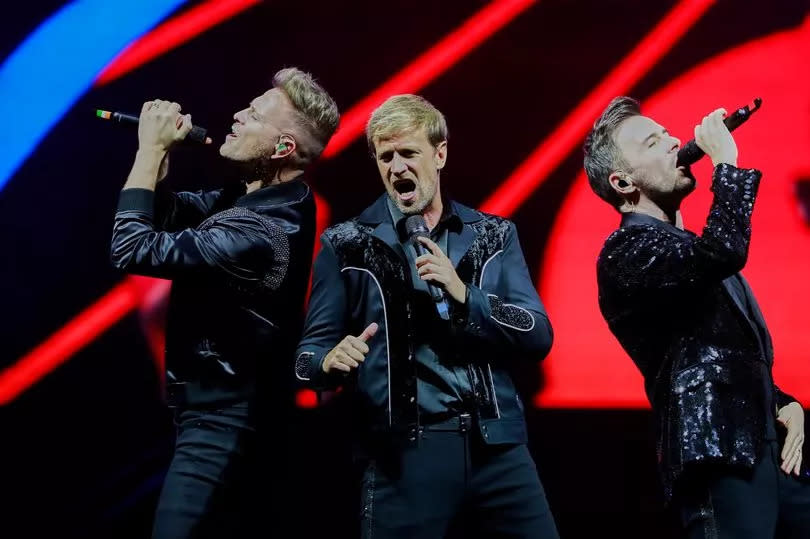 Nicky Byrne, Shane Filan and Kian Egan of Westlife perform on stage during a concert in Mexico