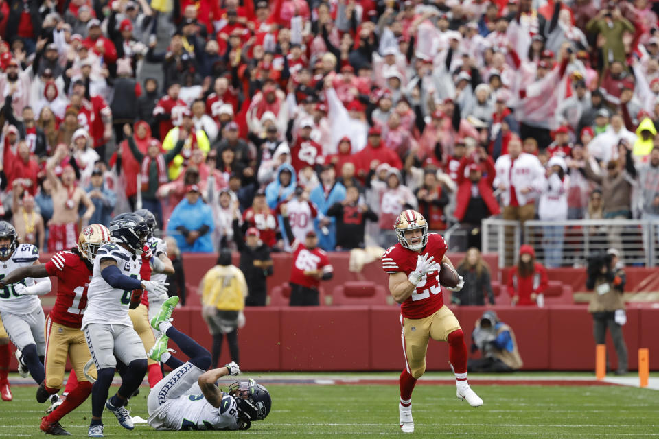 San Francisco 49ers running back Christian McCaffrey (23) runs against the Seattle Seahawks during the first half of an NFL wild card playoff football game in Santa Clara, Calif., Saturday, Jan. 14, 2023. (AP Photo/Josie Lepe)