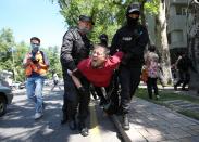 Kazakh law enforcement officers detain a man during an opposition rally in Almaty