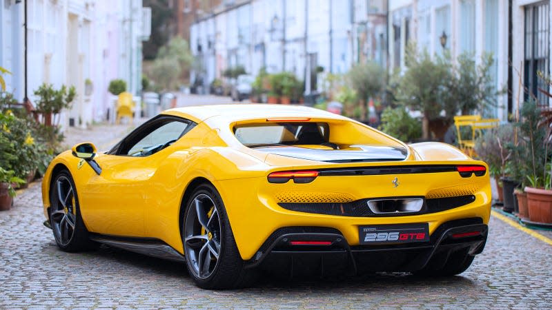 A photo of a yellow Ferrari 296GTB sports car on a street in London. 