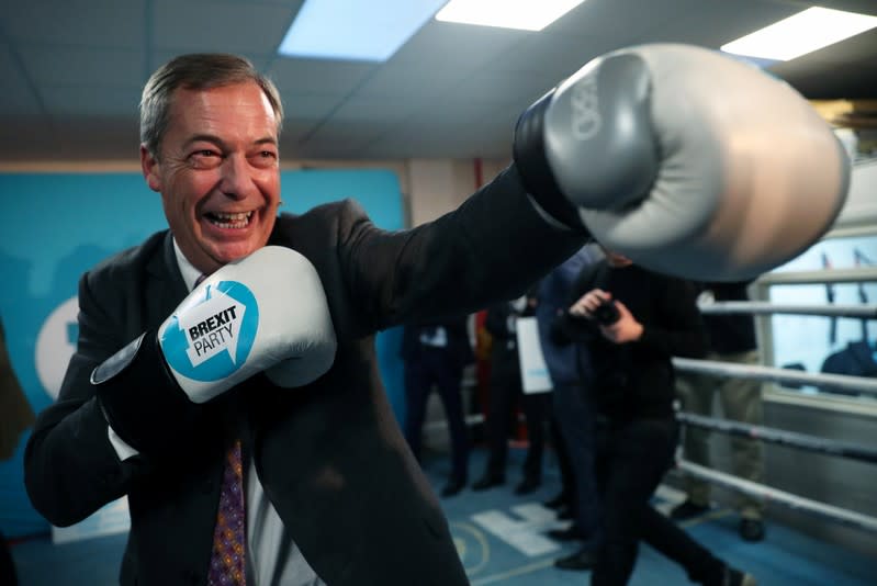 Brexit Party leader Nigel Farage wears boxing gloves during a visit at a boxing gym in Ilford