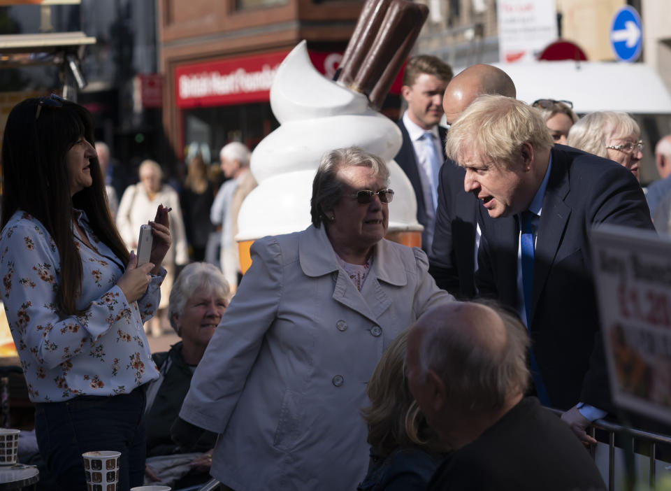 Britain's Prime Minister Boris Johnson speaks with members of the public during a visit to Doncaster Market, in Doncaster, Northern England, Friday Sept. 13, 2019. Johnson will meet with European Commission president Jean-Claude Juncker for Brexit talks Monday in Luxembourg. The Brexit negotiations have produced few signs of progress as the Oct. 31 deadline for Britain’s departure from the European Union bloc nears. ( AP Photo/Jon Super)