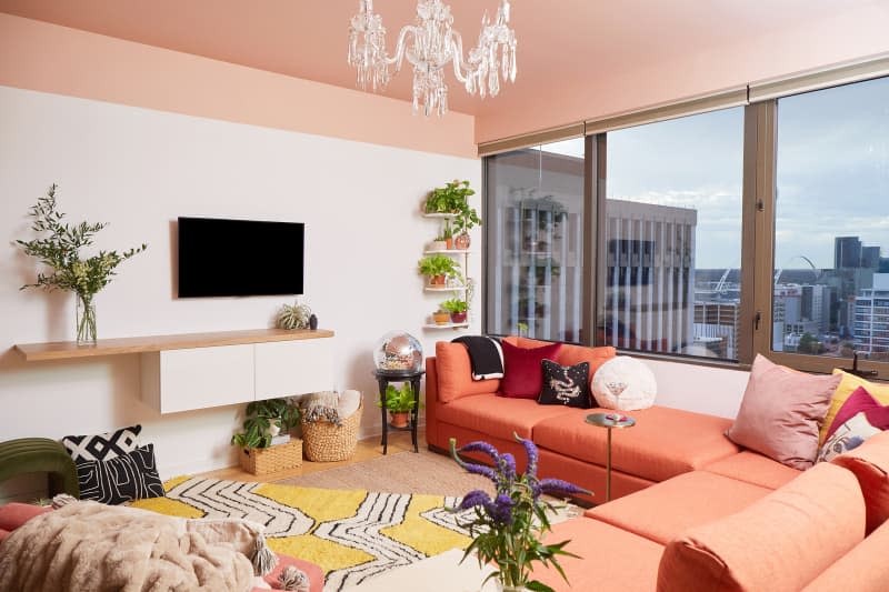 Wall mounted media center in pink living room.