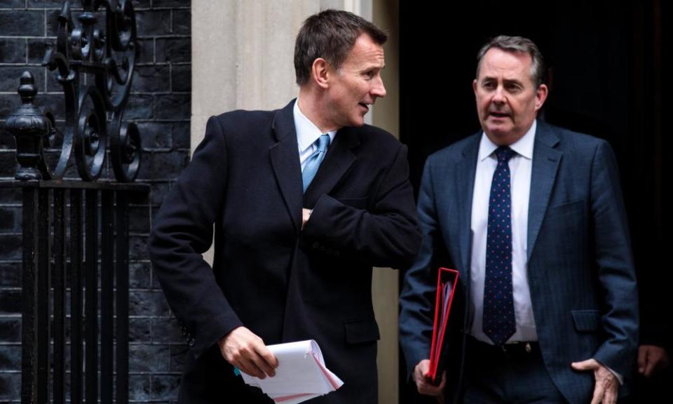 Cabinet members Jeremy Hunt and Liam Fox leave Downing Street.