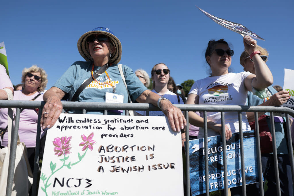 A group of people holding signs advocating abortion rights