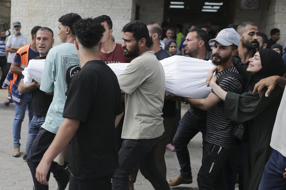 Palestinians mourn carry the body of a relative killed in an Israeli airstrike, at Al-Aqsa Martyrs Hospital in Deir al Balah, Gaza Strip, Monday, June 10, 2024. (AP Photo/Jehad Alshrafi)