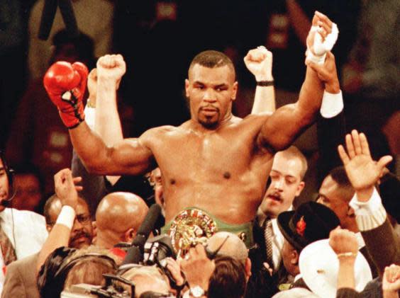 Tyson held the WBA, WBC and IBF belts (Getty)