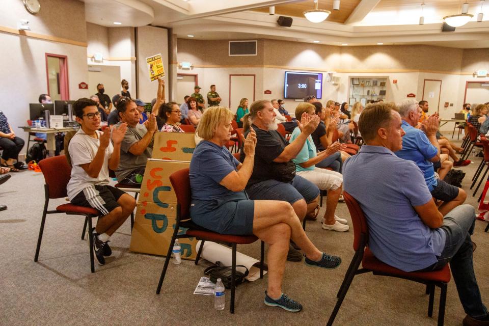 People applaud a public commenter during a Desert Sands Unified School District regular board meeting in La Quinta, Calif., on August 17, 2021. Several public commenters asked for a no masking requirement in schools. 