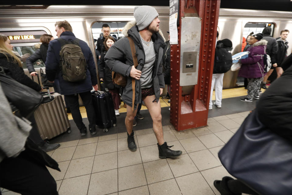 A pantless man leaves an E Train at the Lexington and 53rd Street Station during the 18th annual No Pants Subway Ride, Jan. 13, 2019, in New York. (Photo: Kathy Willens/AP)