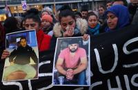 People attend a vigil for the victims of a shooting in Hanau