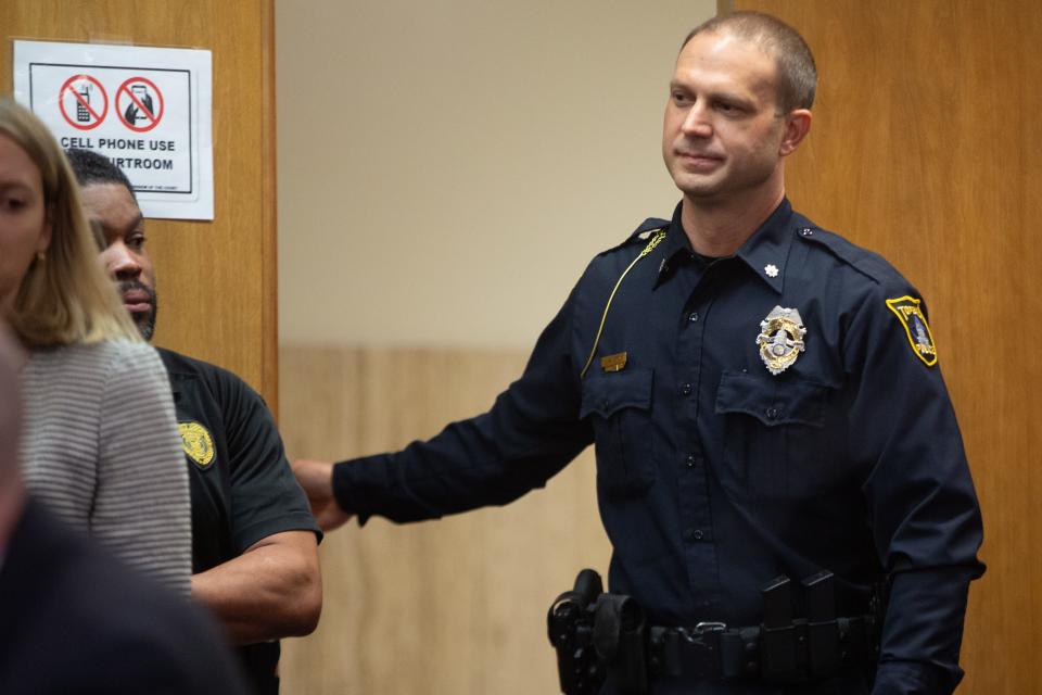 Topeka Deputy Police Chief Jamey Haltom walks in to the courtroom to take the witness stand at Tuesday's trial.