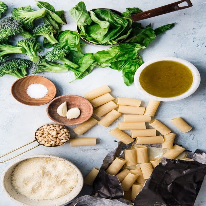 Broccoli, pasta, grated Parmesan, and other ingredients for pasta.