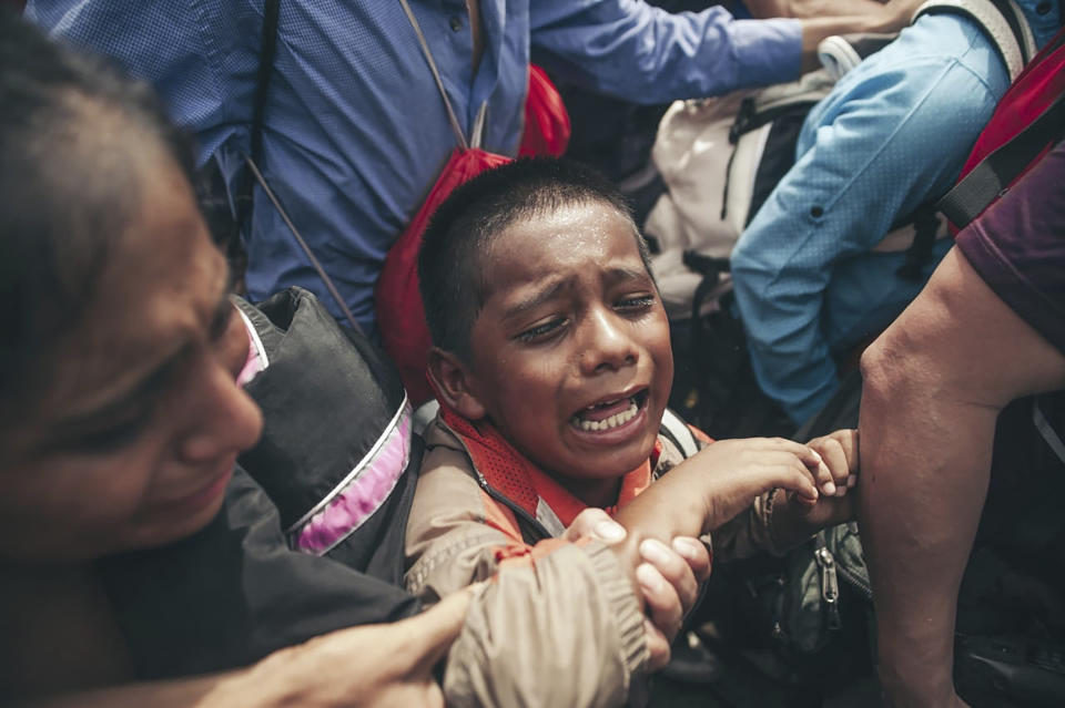 Migrants are detain by Mexican authorities in Tapachula, Chiapas state, Mexico on October 12, 2019. - A caravan of 2,000 migrants, among Central Americans, Caribbean and Africans, began to march this Saturday from Tapachula, in southern Mexico, heading to the capital of the country, to demand President Andres Manuel Lopez Obrador help to get out of their legal limbo. (Photo by Daniel ZACARIAS / AFP) / The erroneous mention[s] appearing in the metadata of this photo by Alfredo ESTRELLA has been modified in AFP systems in the following manner: [AFP PHOTO / DANIEL ZACARIAS] instead of [AFP PHOTO / ALFREDO ESTRELLA. Please immediately remove the erroneous mention[s] from all your online services and delete it (them) from your servers. If you have been authorized by AFP to distribute it (them) to third parties, please ensure that the same actions are carried out by them. Failure to promptly comply with these instructions will entail liability on your part for any continued or post notification usage. Therefore we thank you very much for all your attention and prompt action. We are sorry for the inconvenience this notification may cause and remain at your disposal for any further information you may require. (Photo by DANIEL ZACARIAS/AFP via Getty Images)