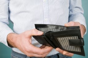 Man holding empty wallet