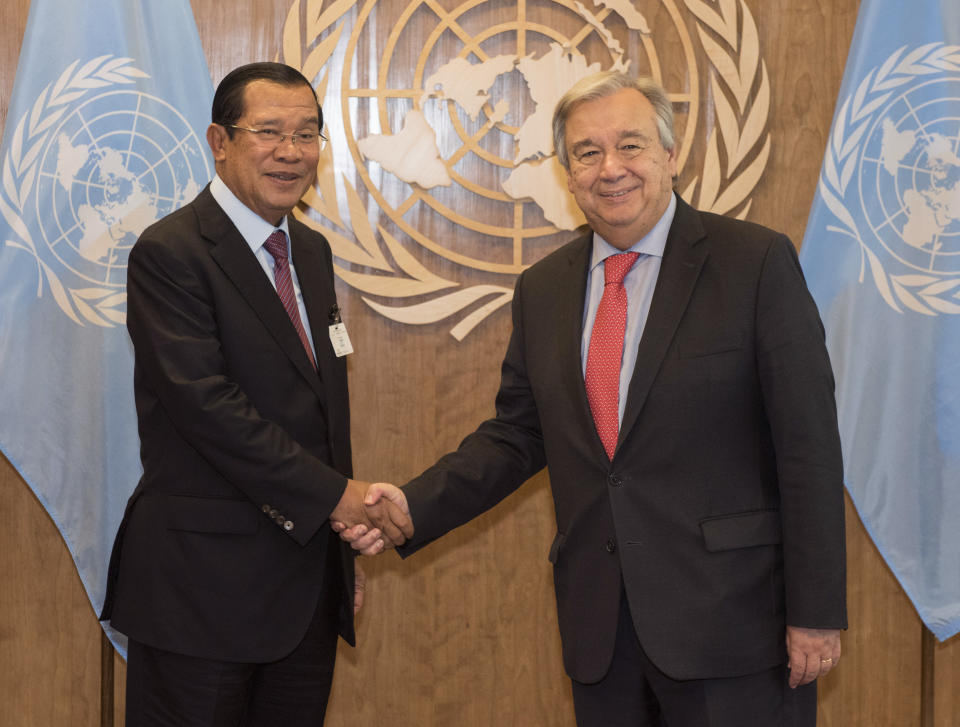 In this photo provided by the United Nations, Samdech Akka Moha Sena Padei Techo Hun Sen, Prime Minister, Kingdom of Cambodia, is greeted by United Nations Secretary-General Antonio Guterres during the United Nations General Assembly, Friday, Sept. 28, 2018 at U.N. Headquarters. (Kim Haughton/The United Nations via AP)