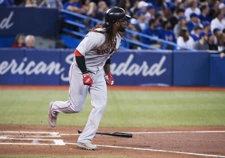 May 12, 2018; Toronto, Ontario, CAN; Boston Red Sox designated hitter Hanley Ramirez (13) hits two run home run during the third inning against the Toronto Blue Jays at Rogers Centre. Mandatory Credit: Nick Turchiaro-USA TODAY Sports