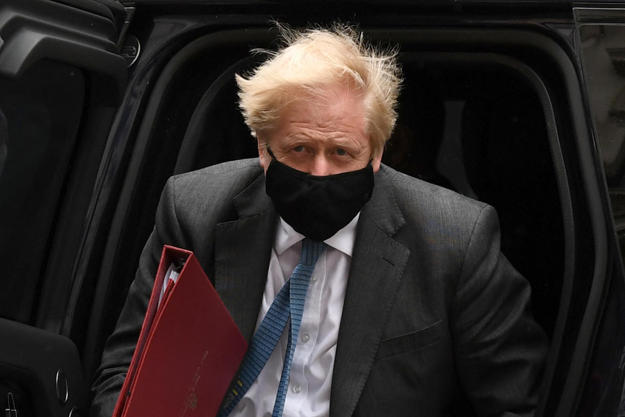 Britain's Prime Minister Boris Johnson wearing a face covering due to Covid-19, arrives back at 10 Downing Street in central London on April 28, 2021. - Britain's Electoral Commission on Wednesday announced a formal probe into how Prime Minister Boris Johnson paid for a lavish makeover of his Downing Street flat, seriously escalating a simmering scandal. (Photo by DANIEL LEAL-OLIVAS / AFP) (Photo by DANIEL LEAL-OLIVAS/AFP via Getty Images)