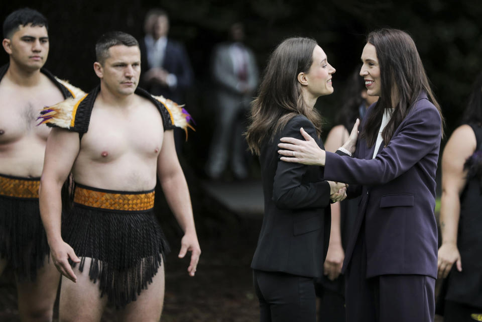 Finland's Prime Minister Sanna Marin, left, is met by New Zealand Prime Minister Jacinda Ardern at the Auckland Museum, in Auckland, New Zealand, Wednesday, Nov. 30, 2022. Marin says it must give more weapons and support to Ukraine to ensure it wins its war against Russia (Michael Craig/New Zealand Herald via AP)