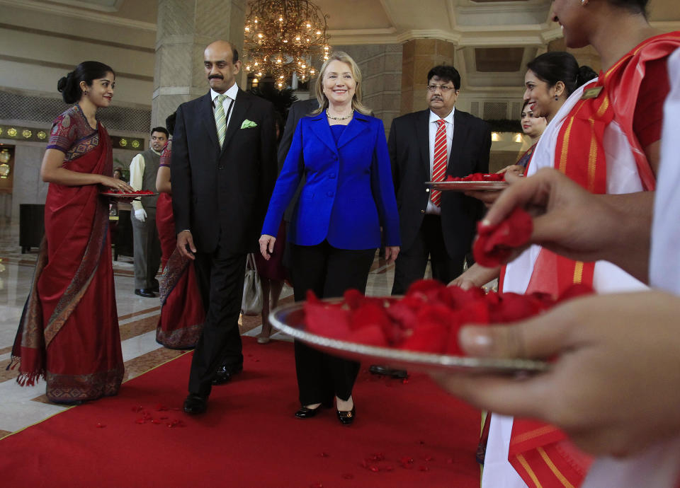 U.S. Secretary of State Hillary Rodham Clinton leaves the Taj Hotel in Kolkata Monday, May 7, 2012. Clinton urged energy-starved India on Monday to reduce its Iranian oil imports to keep up pressure on the Islamic republic to come clean about its nuclear program. (AP Photo/Shannon Stapleton, Pool)