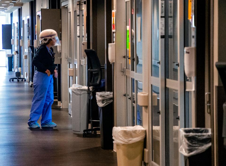 A nurse looks in on a patient's room in the COVID ICU at SSM Health St. Anthony Hospital in Oklahoma City on Aug. 24.