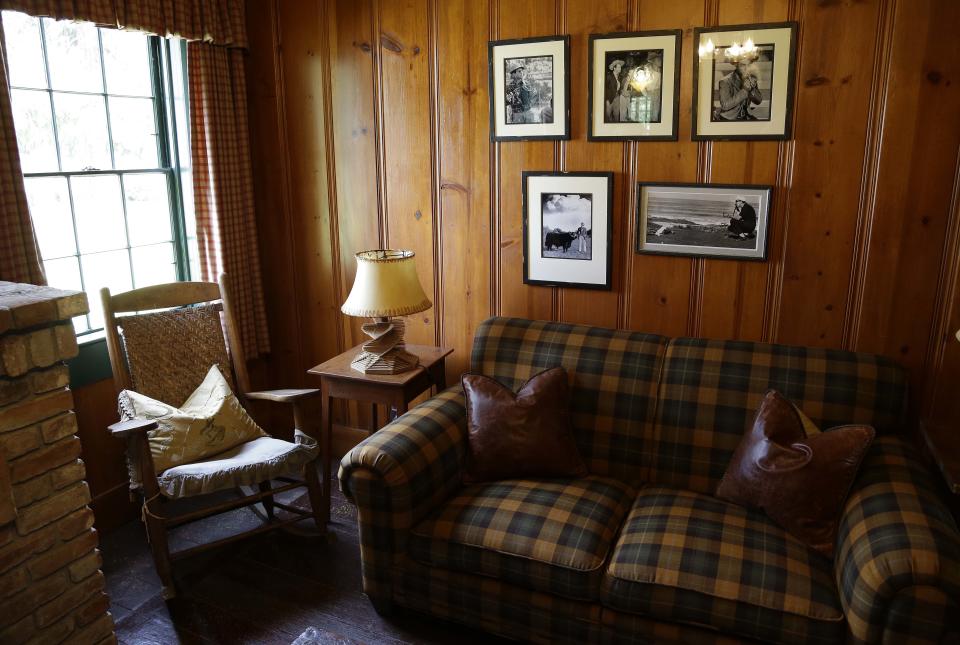 In this photo taken March 15, 2013 a selection of old photographs hang in a study beside actor Fred MacMurray's rocking chair at the MacMurray Ranch in Healdsburg, Calif. The former cattle ranch, which was purchased in 1941 by the actor in the popular TV series "My Three Sons," now produces wine and is owned by the Gallo wine family. (AP Photo/Eric Risberg)