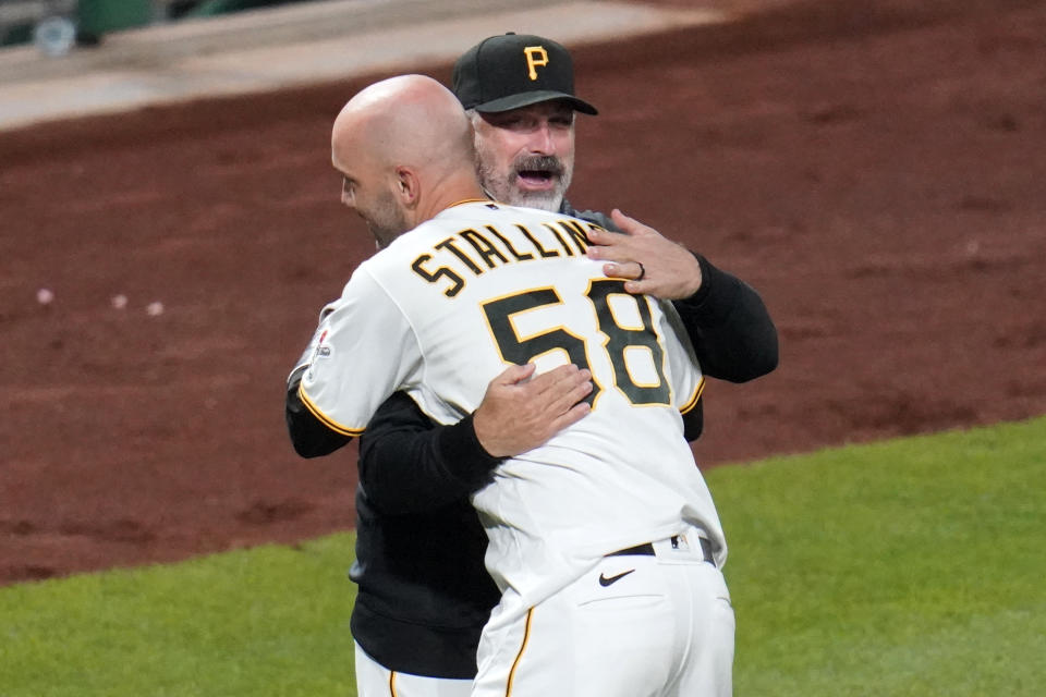 Pittsburgh Pirates' Jacob Stallings (58) gets a hug from manager Derek Shelton after hitting a solo, walk off home run off Chicago Cubs relief pitcher Andrew Chafin during the bottom of the ninth inning of a baseball game in Pittsburgh, Tuesday, Sept. 22, 2020. The Pirates won 3-2. (AP Photo/Gene J. Puskar)