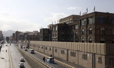 Vehicles drive past the office building of Ahmed Awadh bin Mubarak, in Sanaa January 17, 2015. REUTERS/Mohamed al-Sayaghi