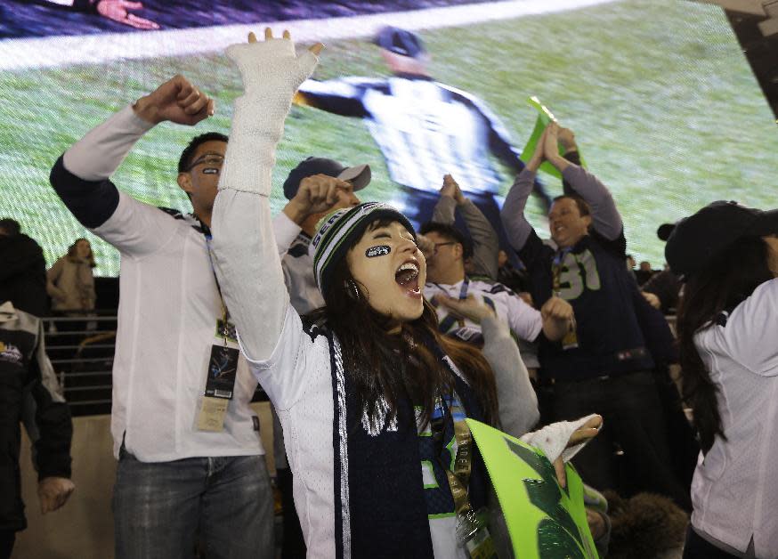 A Seattle Seahawks fan celebrates as the Seahawks come up with a safety against the Denver Broncos the NFL Super Bowl XLVIII football game Sunday, Feb. 2, 2014, in East Rutherford, N.J. (AP Photo/Seth Wenig)