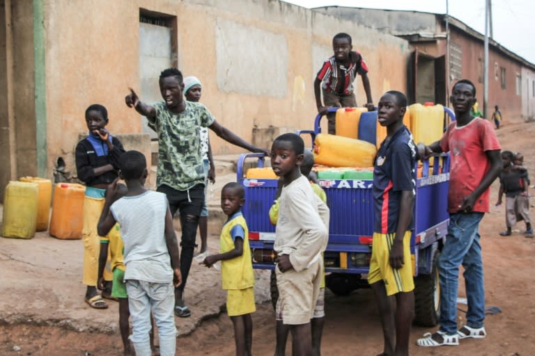 After three weeks of dry taps in a time of drought, residents queue for well water in Ivory Cast's second city, Bouake