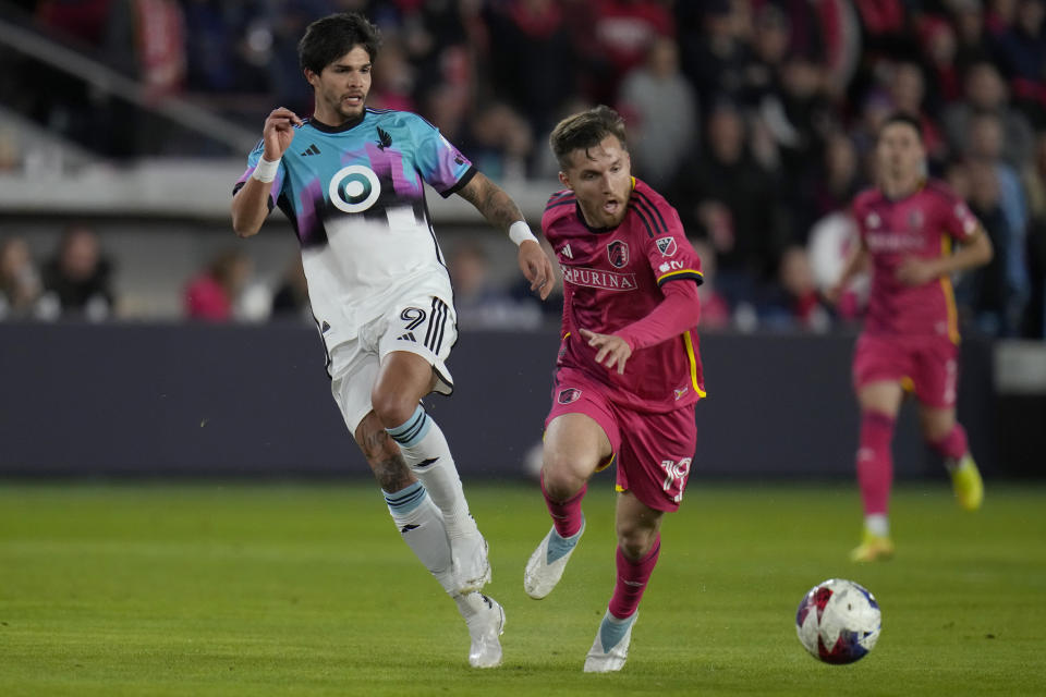 St. Louis City's Indiana Vassilev chases the ball as Minnesota United's Luis Amarilla (9) defends during the first half of an MLS soccer match Saturday, April 1, 2023, in St. Louis. (AP Photo/Jeff Roberson)