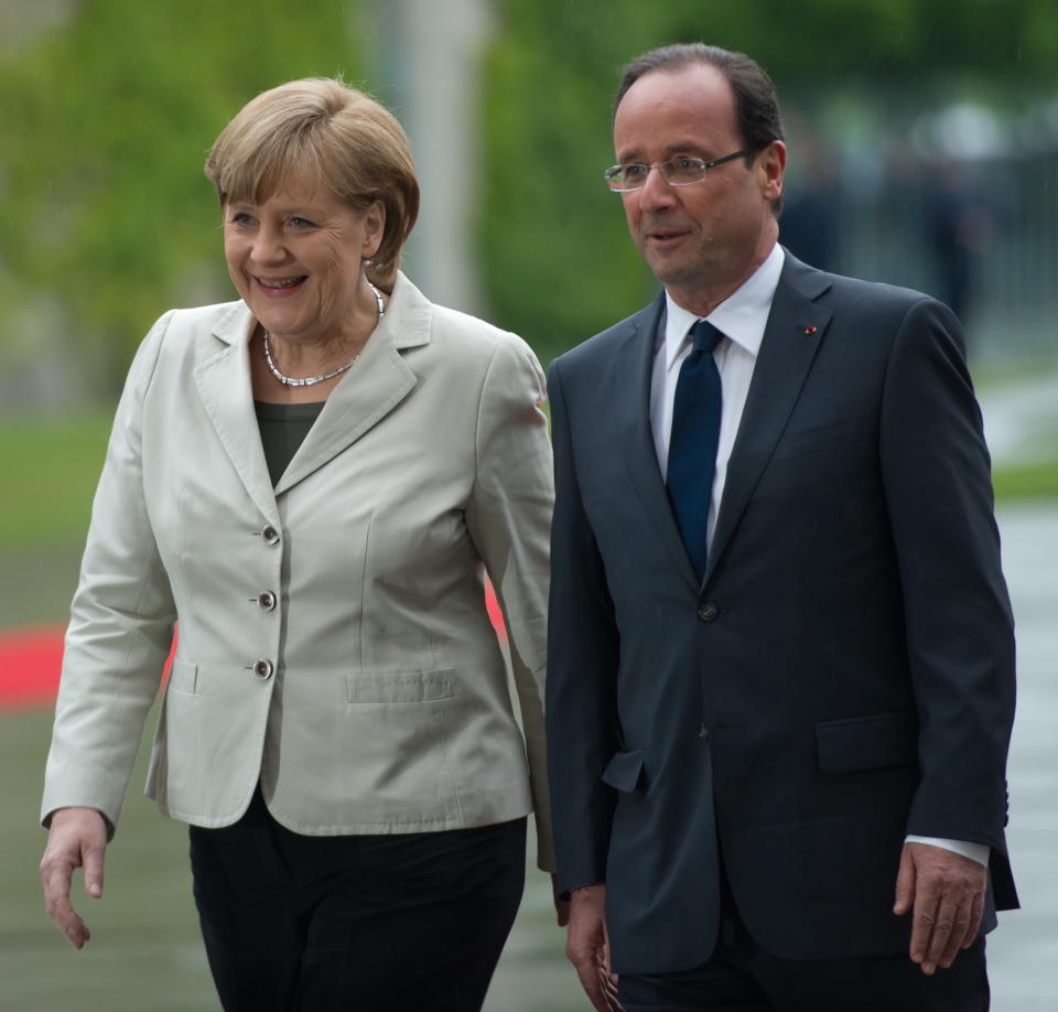 German Chancellor Angela Merkel, left, welcomes the President of France, Francois Hollande, right, at the chancellery in Berlin, Germany, Tuesday, May 15, 2012. The French president's first foreign trip since taking office earlier Tuesday continues a tradition for leaders of both countries to visit each other shortly after inauguration. The talks are expected to be dominated by Europe's debt crisis. (AP Photo/dapd/Maja Hitij)