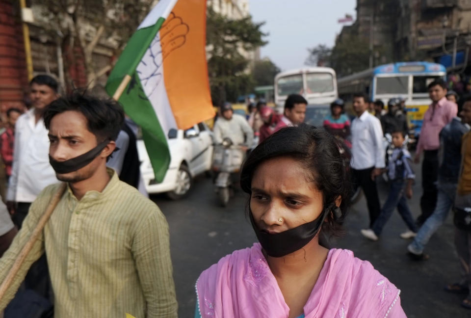 FILE - In this Friday, Jan. 3, 2014 file photo, activists of Indian National Congress with black bands around their mouths block traffic during a protest against a gang rape and murder of a 16-year-old girl at Madhyamgram, about 25 kilometers (16 miles) north of Kolkata in West Bengal, India. Her death on New Year's Eve came more than a year after a deadly gang rape in New Delhi raised awareness and outrage over chronic sexual violence in India and government failures to protect women. The New Delhi rape was considered a major reason for why voters ousted the capital's government last month, and the furious response to the West Bengal case suggests that with general elections just months away, politicians remain anxious to impress voters who are demanding that women's safety become a police priority. (AP Photo/Bikas Das, File)