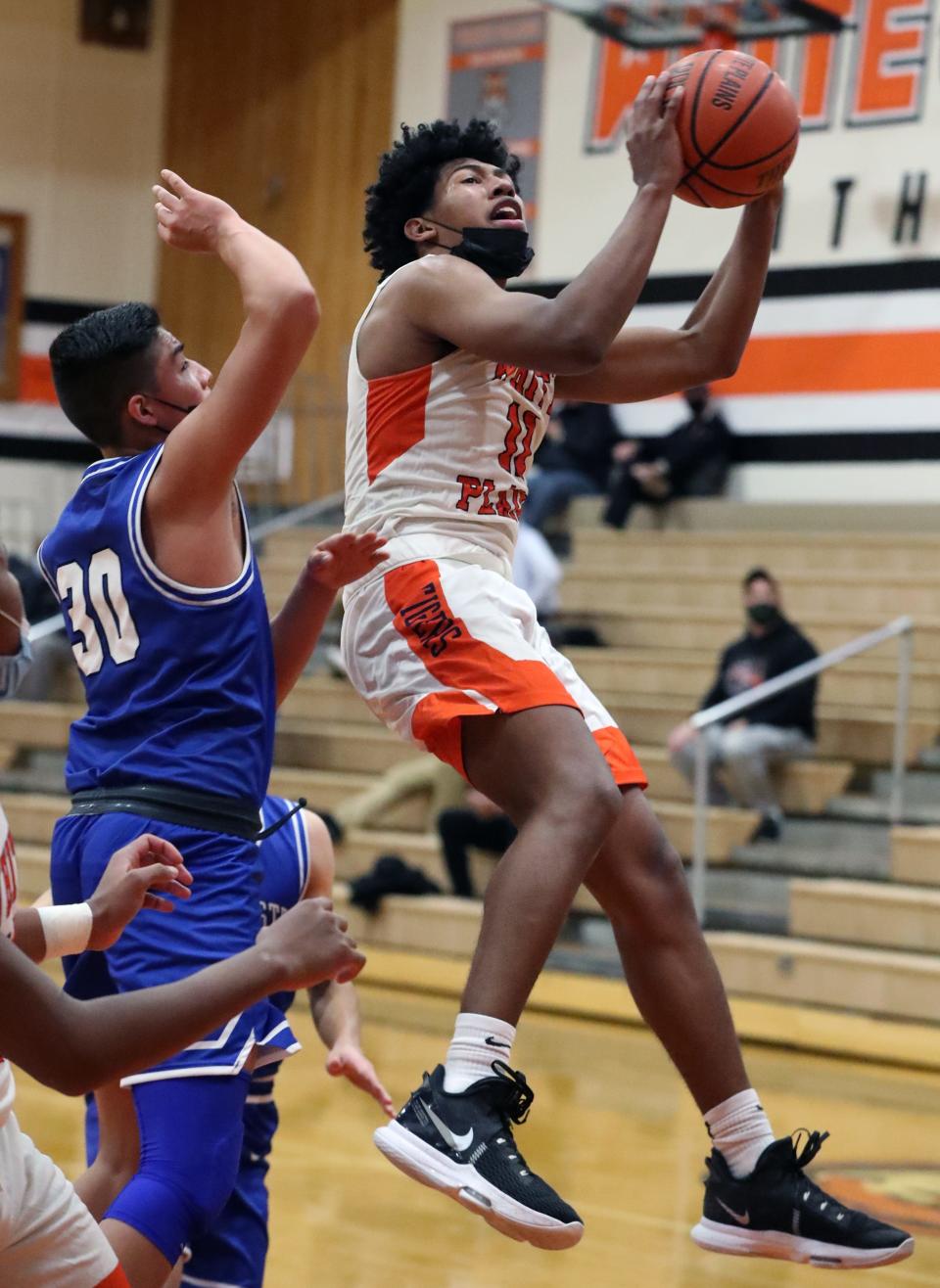 White Plains' Menzy Carden is pressured by Port Chester's Brandon Nieto during their game at White Plains Jan. 6, 2022. White Plains won 69-48.