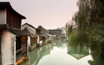 <p><strong>What to See:</strong> About 80 miles inland from Shanghai, Wuzhen is one of a handful of historic canal towns given special recognition by China at the end of the Yangtze Rivers long route. Often compared to Venice for its abundant waterways, Wuzhen offers visitors similar opportunities to immerse themselves in culture. Experience its traditional shadow plays and Huagu Opera, its wedding and even ancient bed museums. And dont forget to take a boat ride.</p><p><strong>Where to Stay: </strong>Try the <a rel="nofollow noopener" href="http://www.wuzhen.com.cn/english/hotel.asp?hid=50" target="_blank" data-ylk="slk:Waterside Resort;elm:context_link;itc:0;sec:content-canvas" class="link ">Waterside Resort</a>, Wuzhens largest hotel, which combines ancient design touches with modern conveniences.</p><p><strong>What to Eat: </strong>Take a break at the riverside at the BuBu LianHua Caf (Xiushuilang Jie, XiZha Scenic Zone), whose al fresco eating area provides patrons with both food and drink.</p>