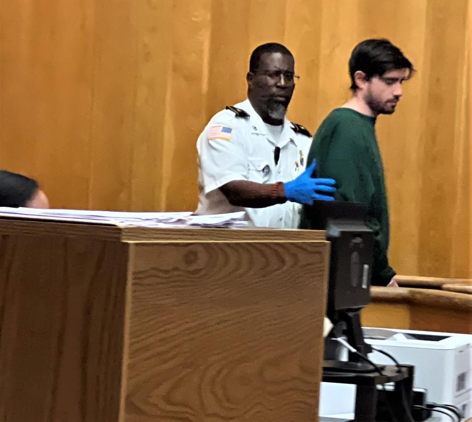 Tyler Dow Baglini is brought into the courtroom by a court officer. He is accused of stabbing Kerri Fidalgo, 31, to death in her New Bedford apartment on Friday, Sept. 20, and is charged with murder.