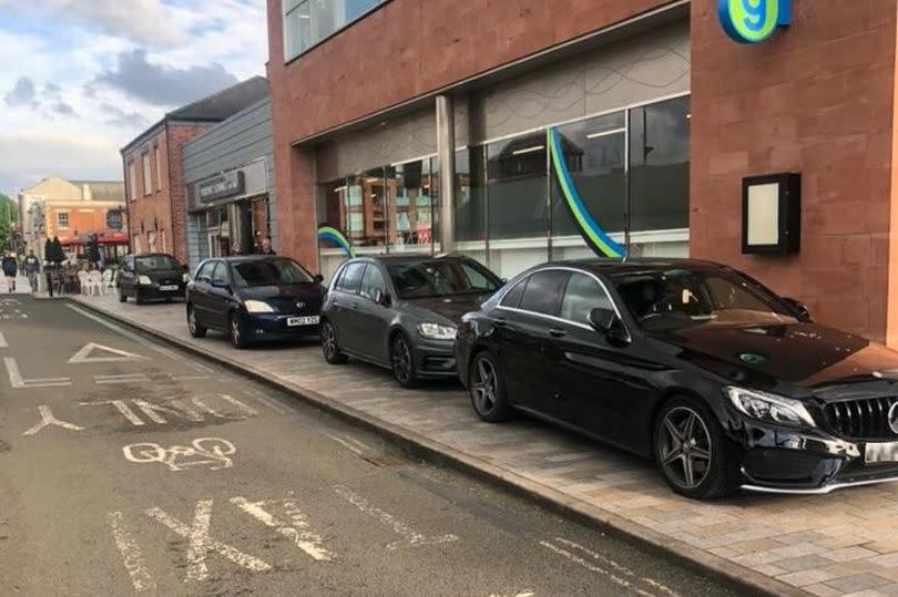 Cars parked on the pavement next to the Quays in Llanthony Road, Gloucester