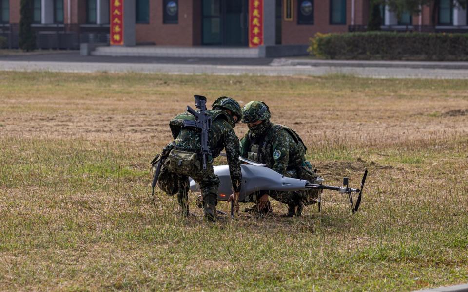Taiwan soldiers prepare a tactical close-range rotary-wing drone during the two-day routine drills to show combat readiness ahead of Lunar New Year holidays at a military base