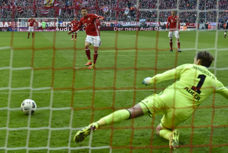 Bayern Munich's Polnish striker Robert Lewandowski scores a penalty during the German first division Bundesliga football match between Bayern Munich and Hamburger SV in Munich, southern Germany, on February 25, 2017