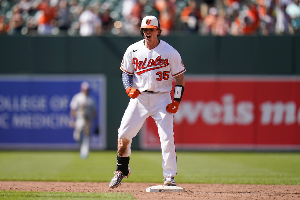 Baltimore Orioles' Adley Rutschman reacts after hitting a double against the Texas Rangers during the ninth inning of a baseball game, Monday, July 4, 2022, in Baltimore. The Orioles won 7-6 in ten innings. (AP Photo/Julio Cortez)