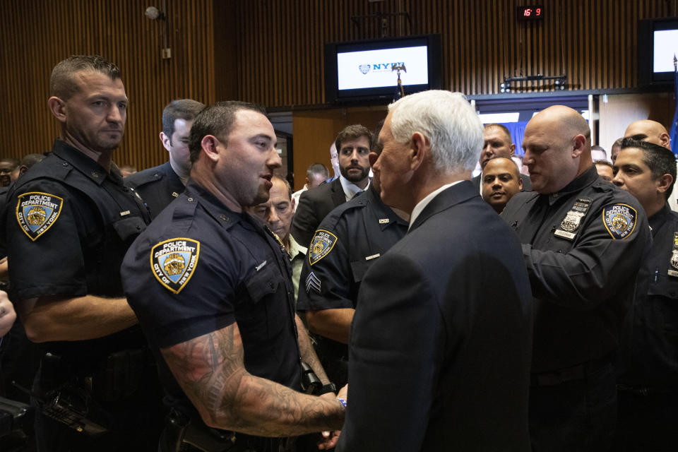 Vice President Mike Pence, right, meets with members of the New York Police Department's football team, Thursday, Sept. 19, 2019. Pence met earlier with the NYPD for a counterterrorism briefing. (AP Photo/Mark Lennihan)