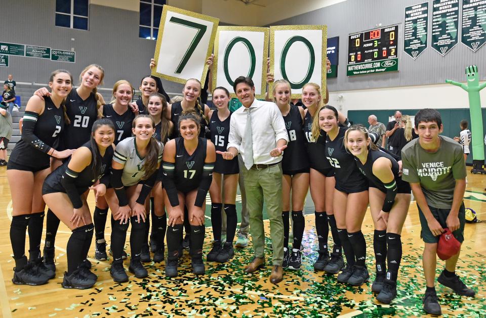 Brian Wheatley, in middle, Venice's High School head volleyball coach with his players, hits the 700th win while hosting a home game against Sarasota High School, Tuesday night, August  22, 2023.