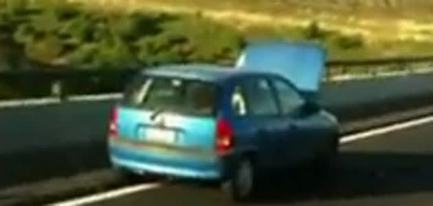 Man drives with hood up. Photo: YouTube