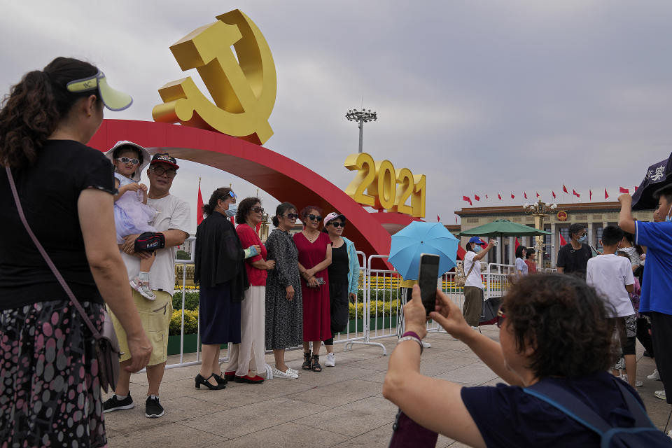 Visitors gather to take souvenir photos with a communist party's logo on display at Tiananmen Square to mark the 100th anniversary of the founding of the ruling Chinese Communist Party in Beijing on Monday, July 5, 2021. Chinese leader Xi Jinping on Tuesday attacked calls from some in the U.S. and its allies to limit their dependency on Chinese suppliers and block the sharing of technologies. (AP Photo/Andy Wong)
