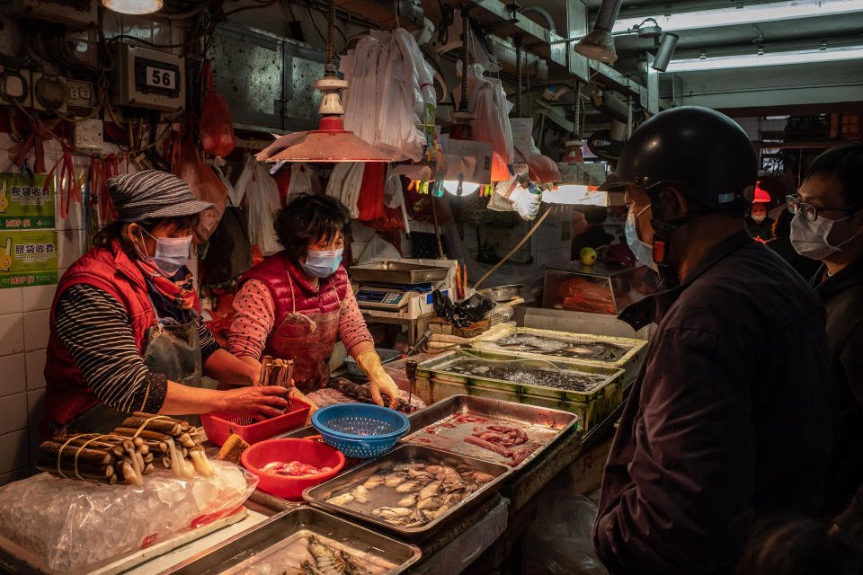 Shoppers wearing face masks purchase seafood at a market on Jan. 28, 2020, in Macau, China. (Photo: Anthony Kwan via Getty Images)