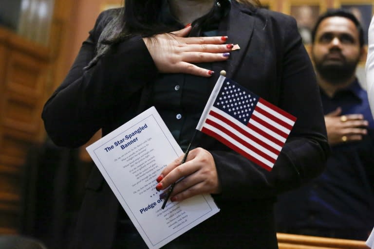 Candidates for US citizenship take the oath of allegiance during a Naturalization Ceremony for new US citizens at the City Hall of Jersey City in New Jersey on February 22, 2017