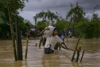 <p>Refugees cross a flooded bridge in the Balukhali Rohingya refugee camp on Sept. 19, 2017 in Cox’s Bazar, Bangladesh. (Photo: Allison Joyce/Getty Images) </p>