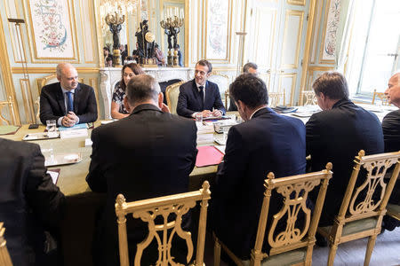 French President Emmanuel Macron faces union representatives during a meeting at the presidential Elysee palace in Paris, France, Tuesday, July 17, 2018. Jean-Francois Badias/Pool via Reuters