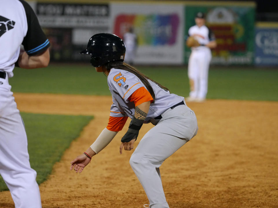 In this photo provided by Joseph Langan, Staten Island FerryHawks' Kelsie Whitmore leads off first as a pinch-runner during a baseball game against the Charleston Dirty Birds on Thursday, April 21, 2022, in Charleston, W.Va. Whitmore played left field and batted ninth for the FerryHawks in Gastonia, N.C., Sunday, May 1, 2022, becoming the first woman to start a game in the Atlantic League and one of the first to do so in a league connected to Major League Baseball. (Joseph Langan via AP)