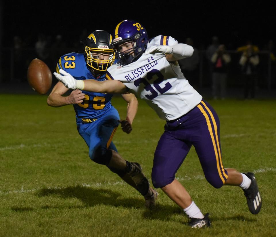 Just out of his reach as Blake Iffland of Blissfield attempts to make the catch with pressure from Joshua Rose of Ida Friday, October 6, 2023.